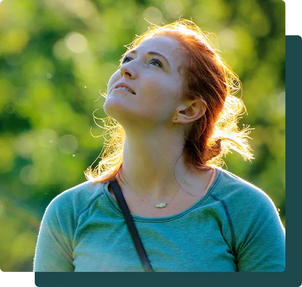 contemplative woman looking up at the sky